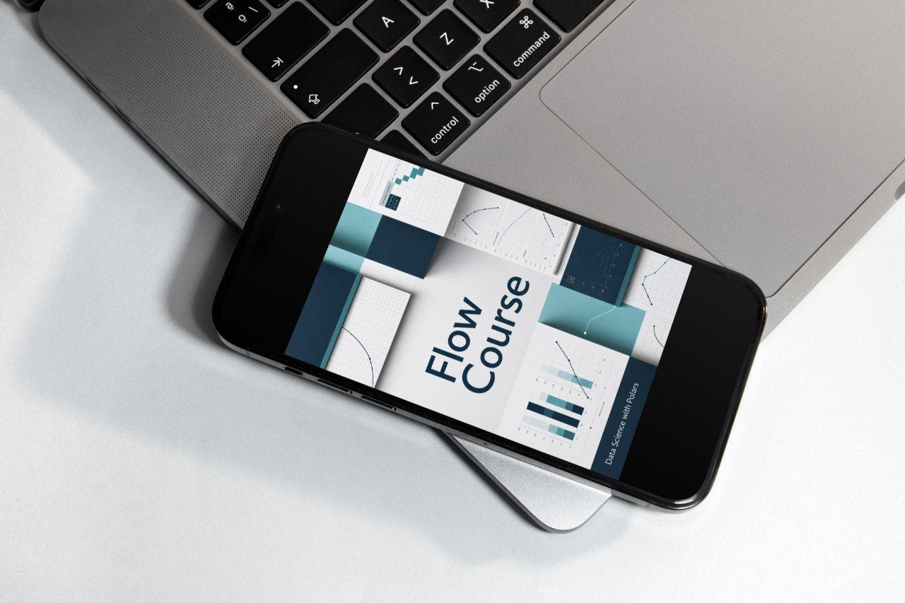 A smartphone lying on a white surface next to a silver laptop, displaying a course cover titled 'Flow Course' with abstract teal, white, and gray geometric graphics.
